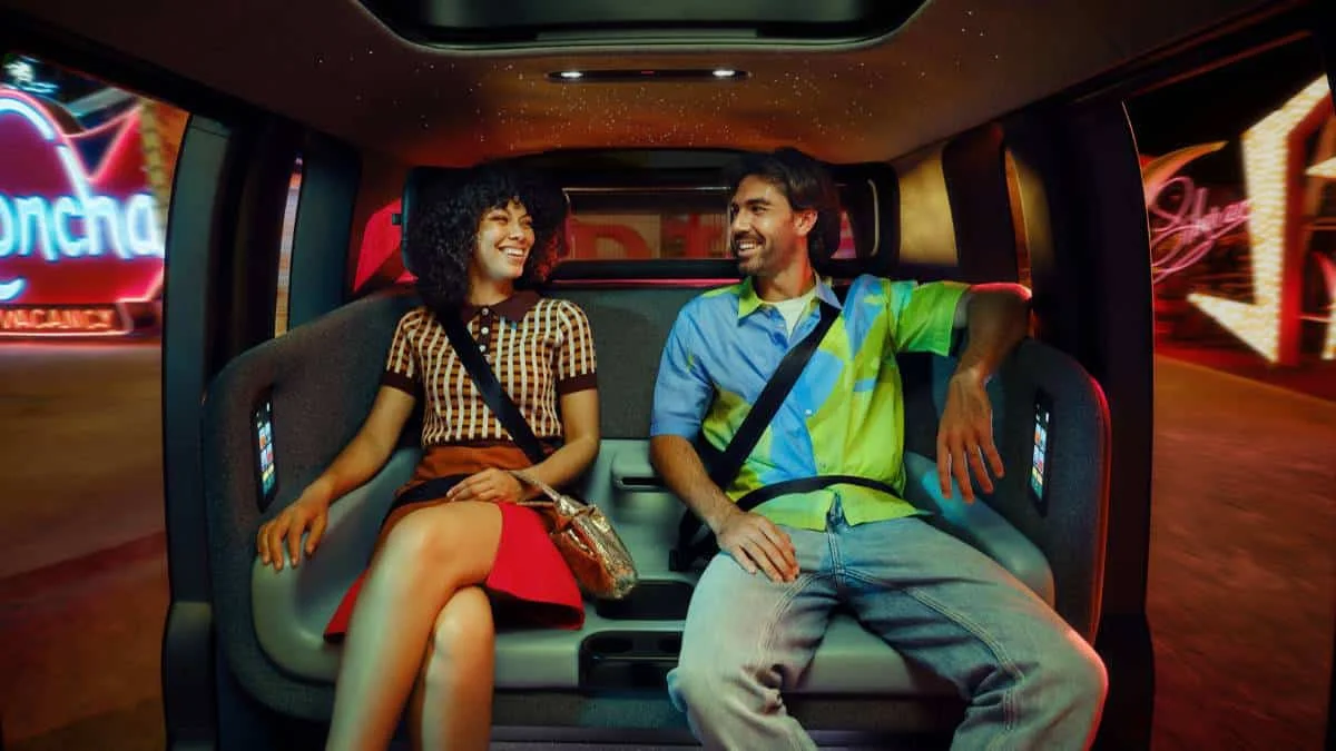 Interior of Zoox robotaxi showing spacious seating and touchscreen controls