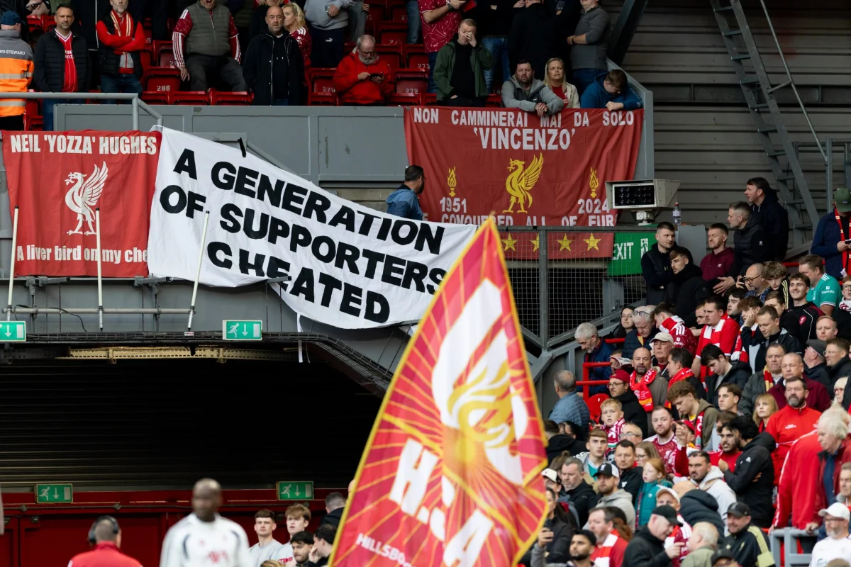 Liverpool fans hold a large banner at Anfield