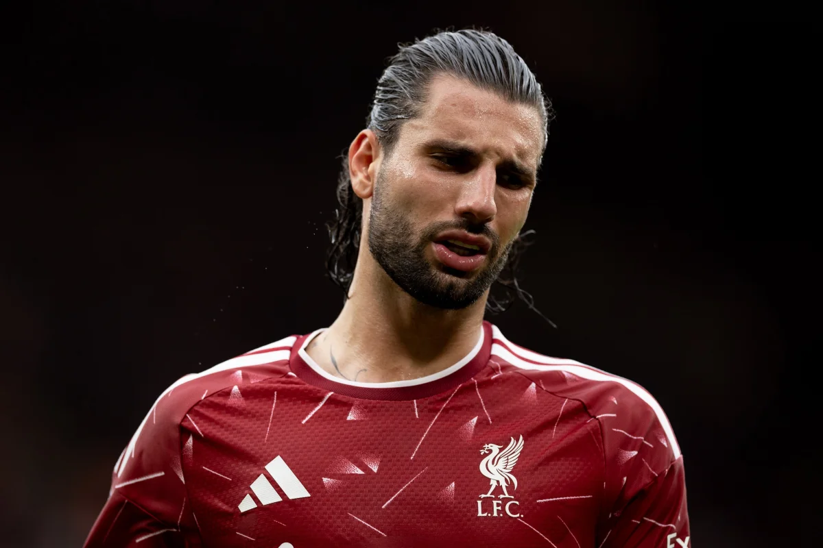 Dominik Szoboszlai in a Liverpool FC shirt, with a disappointed expression.