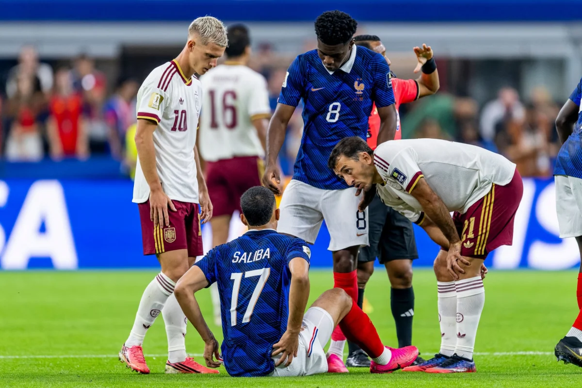 Mandatory Credit: Photo by images/NurPhoto/Shutterstock (16991505jn) William Saliba of France sits injured on the ground while Dani Olmo of Spain, Aurelien Tchouameni of France and Mikel Oyarzabal of Spain ask how things are going during the 2026 World Cup match between France and Spain at Dallas Stadium on July 14, 2026, in Dallas, United States. France v Spain: Semi Final - FIFA World Cup 2026, Dallas, United States - 14 Jul 2026